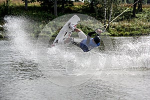 Wakeboarder jumping upside down