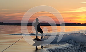 Wakeboarder making tricks on sunset