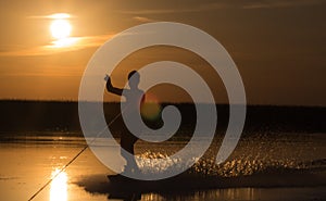 Wakeboarder making tricks on sunset