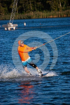 Wakeboarder is training in a cable park