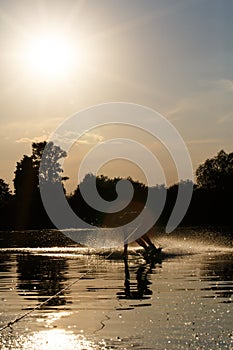 Wakeboarder silhouette against the sunset
