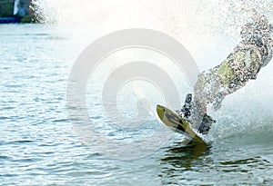 Wakeboarder sportman splash water in the cable park, sport and active lifestyle