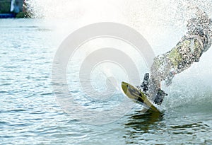 Wakeboarder sportman splash water in the cable park, sport and active lifestyle photo