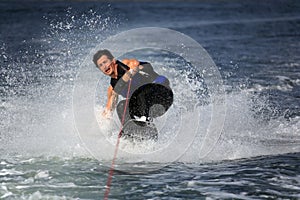 Wakeboarder in water splash