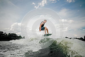 Wakesurf rider jumping on the waves of a river photo
