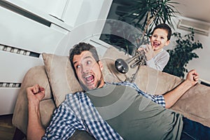 Son wakes up his dad by playing a trumpet photo