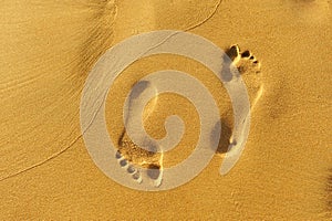 Walk along the beach, footprints in the golden sand