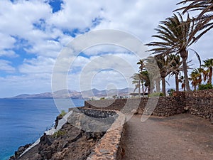 Walk along the coast between the coastal towns of Puerro del Carmen and Puerto Calero. Lanzarote, Spain photo