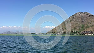 Walk by beautiful lake on boat. Summer day, Blue water. Huge Lake Skadar Montenegro. Largest lake in Montenegro. Trip by