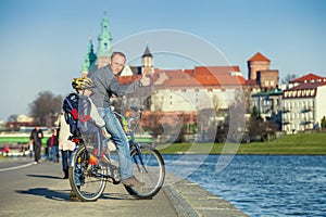 Walk on bike. Father with son cycling in city
