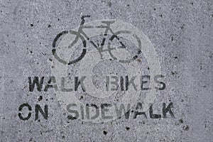Walk bikes on sidewalk sign