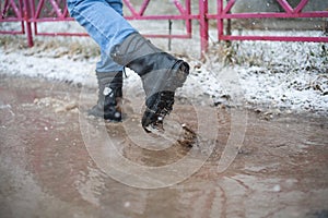 Walk through the city through puddles and snow