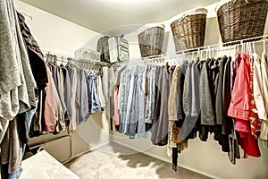 Walk-in closet with clothes photo