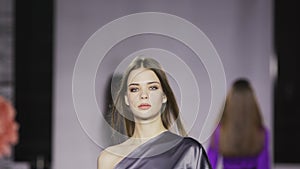 Walk defile slow motion girl dress catwalk model show vogue. Woman on podium.