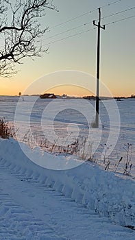 Walk down a dirt road on a very frosty day just before sunset