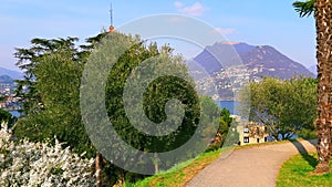 Walk down flowering green Parco Panoramico Paradiso, Switzerland