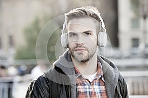 While walk. Online education courses. Listen music. Ebook audio concept. Student study use headphones. Handsome man