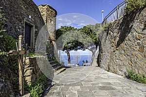 Walk pass to the mirador at Riomaggiore Castle. The wall, entrance and tower of the castle are at left.  Cinque Terre, Italy