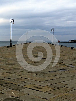 Walk on the pier in winter, Molo Audace, Trieste, Italy