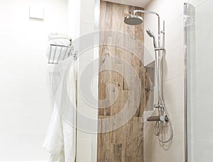 Walk in shower in bathroom with wooden style tile