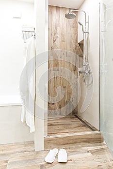 Walk in shower in bathroom with wooden style tile