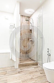 Walk in shower in bathroom with wooden style tile