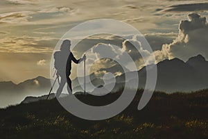 Walk in solitude on the Alps. A woman on with the background of photo