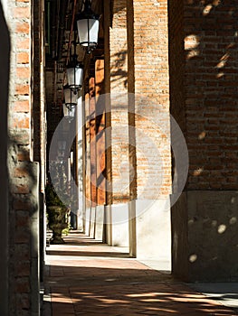 Walk way in brick building with shadow