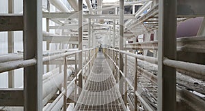 Walk way with  handrail have cable ladder and steam pipe inside  pulp industial