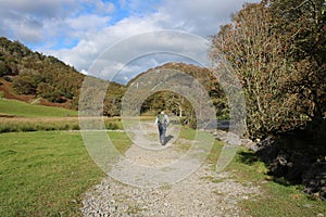Walker with rucsac on footpath in Borrowdale, UK