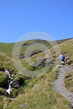 Walker on stony footpath by Scales Beck Blencathra