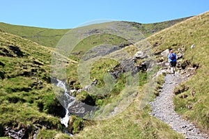 Walker on stony footpath by Scales Beck Blencathra
