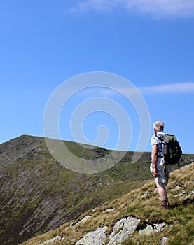 Walker and view from Scales Fell to Blencathra