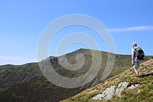 Walker and view from Scale Fell to Blencathra