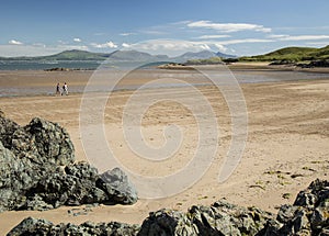 Walkers on beach at Newborough, Anglesey Wales photo