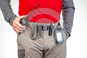 walkie-talkie, flashlight, knife, GPS navigator on the belt of the tourist trekking pants. equipment for tourism and travel. EDC