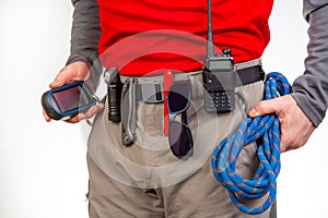 walkie-talkie, flashlight, knife, GPS navigator, climbing rope on the belt of the tourist trekking pants. equipment for tourism