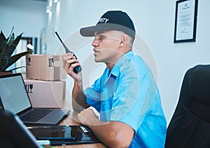 Walkie talkie, security guard and man at table in surveillance, communication in an office. Safety, protection and