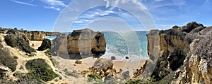 Walking along the cliffs and beach of Praia Da Coelha and Praia do Castelo in Algarve, south of Portugal