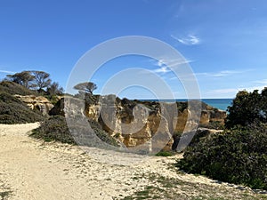 Walking along the cliffs and beach of Praia Da Coelha and Praia do Castelo in Algarve, south of Portugal