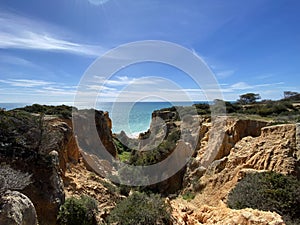 Walking along the cliffs and beach of Praia Da Coelha and Praia do Castelo in Algarve, south of Portugal