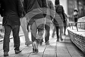 Walking along High Line in Manhattan, New York City. Detail on moving people legs