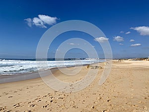 Walking along the sandy beach of Praia Da Gale in Algarve, south of Portugal