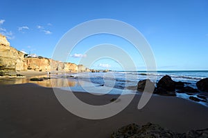 Walking along the sandy beaches and cliffs in Praia Do Alemao, Portimao in Algarve, southern Portugal