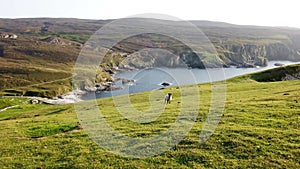 Walking at the amazing coastline at Port between Ardara and Glencolumbkille in County Donegal - Ireland.