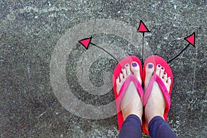 Walking Arrows Directions Drawn. Woman Wear Flip Flop Red and Yellow Standing on Cement Background