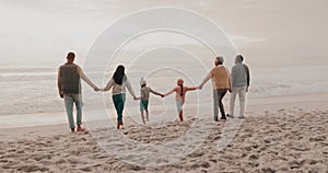 Walking, back and big family holding hands on beach while on tropical vacation or holiday. Adventure, sunset and