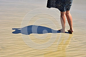 Walking barefoot on fine beach sand