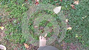 Walking barefoot foot grass and ground
