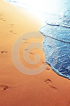 Walking on the beach, leaving footprints in the sand